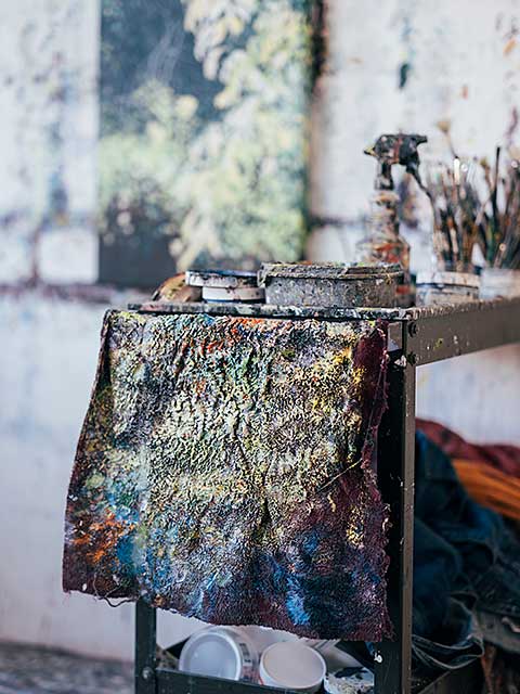 Detail of the cart Angelita uses in her studio, showing a very paint-covered cloth