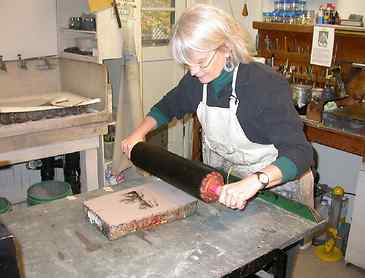 Step 2: Inking the stone, After the surface of the stone is flooded with water, the stone is inked with oily printer's ink
